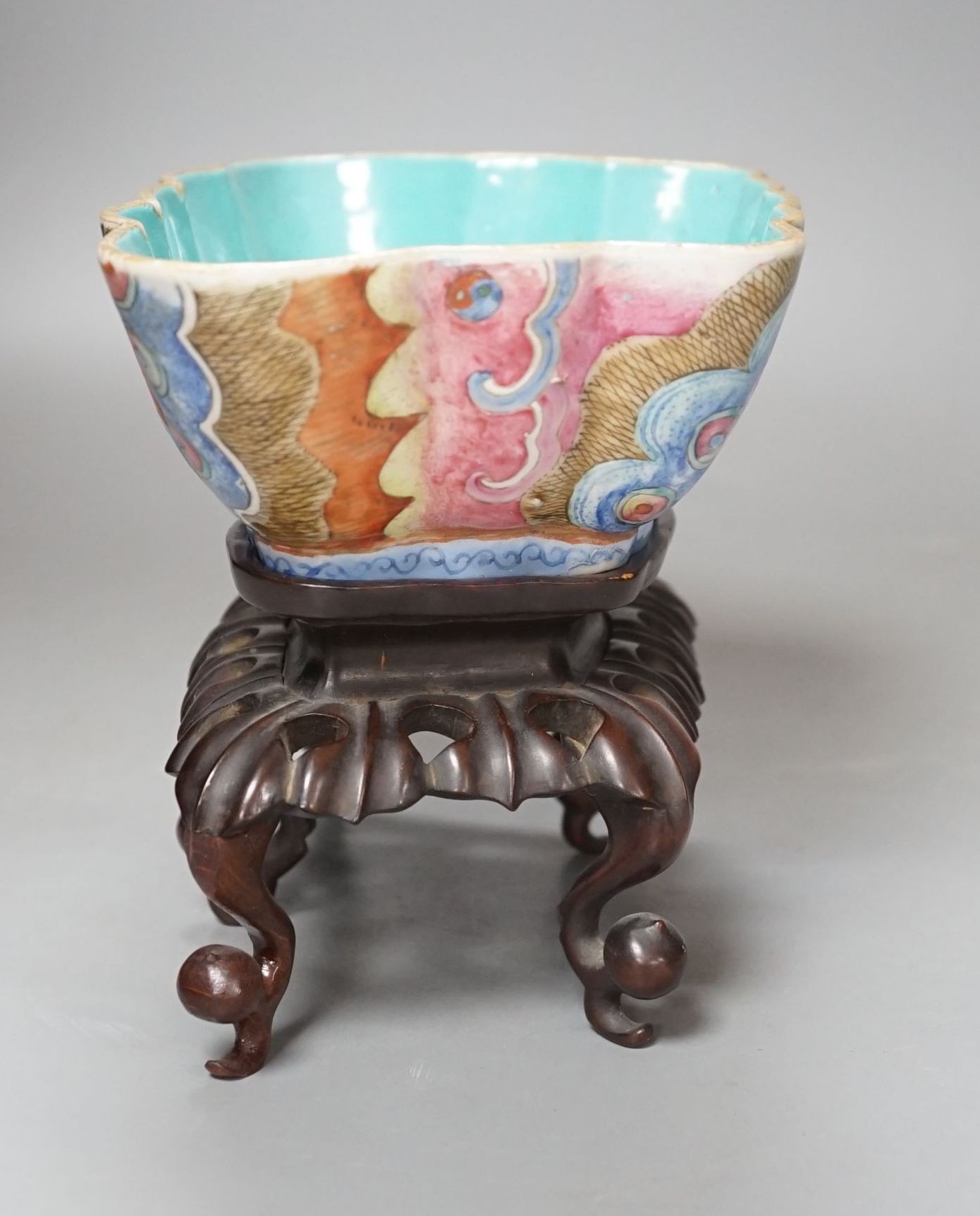 A 19th century Chinese enamelled porcelain ‘butterfly’ bowl, hongmu stand, 21 cms wide x 8 cms high.